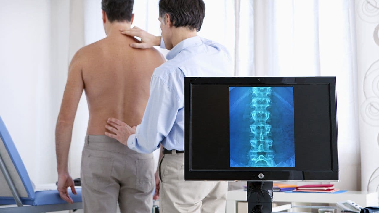 Spine surgeon operating in modern theatre